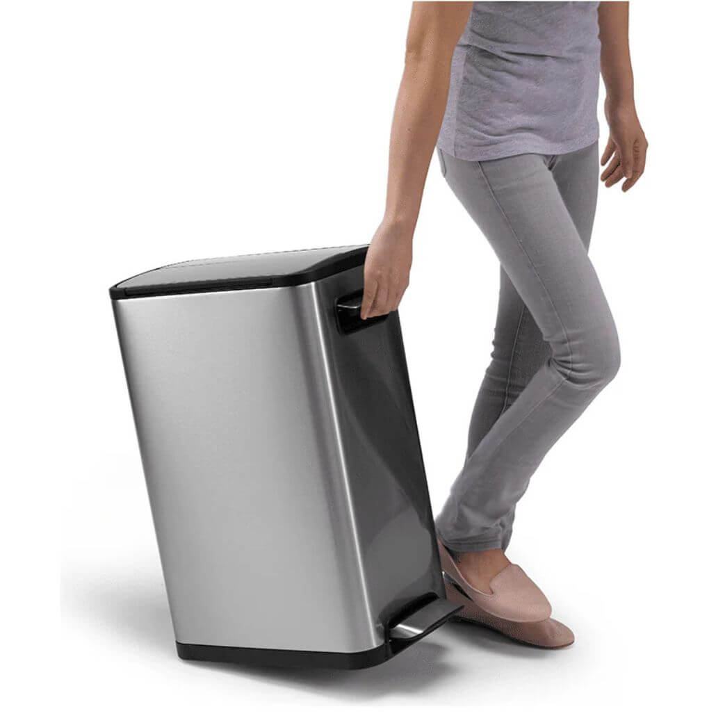 Person using a modern waste bin on a white background