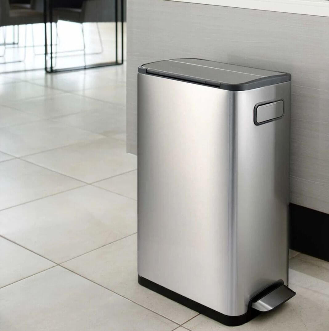 Stainless steel waste bin on a tiled floor