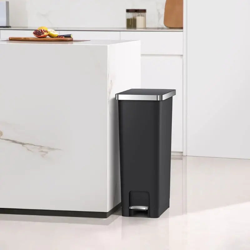 Black pedal bin in a white contemporary kitchen