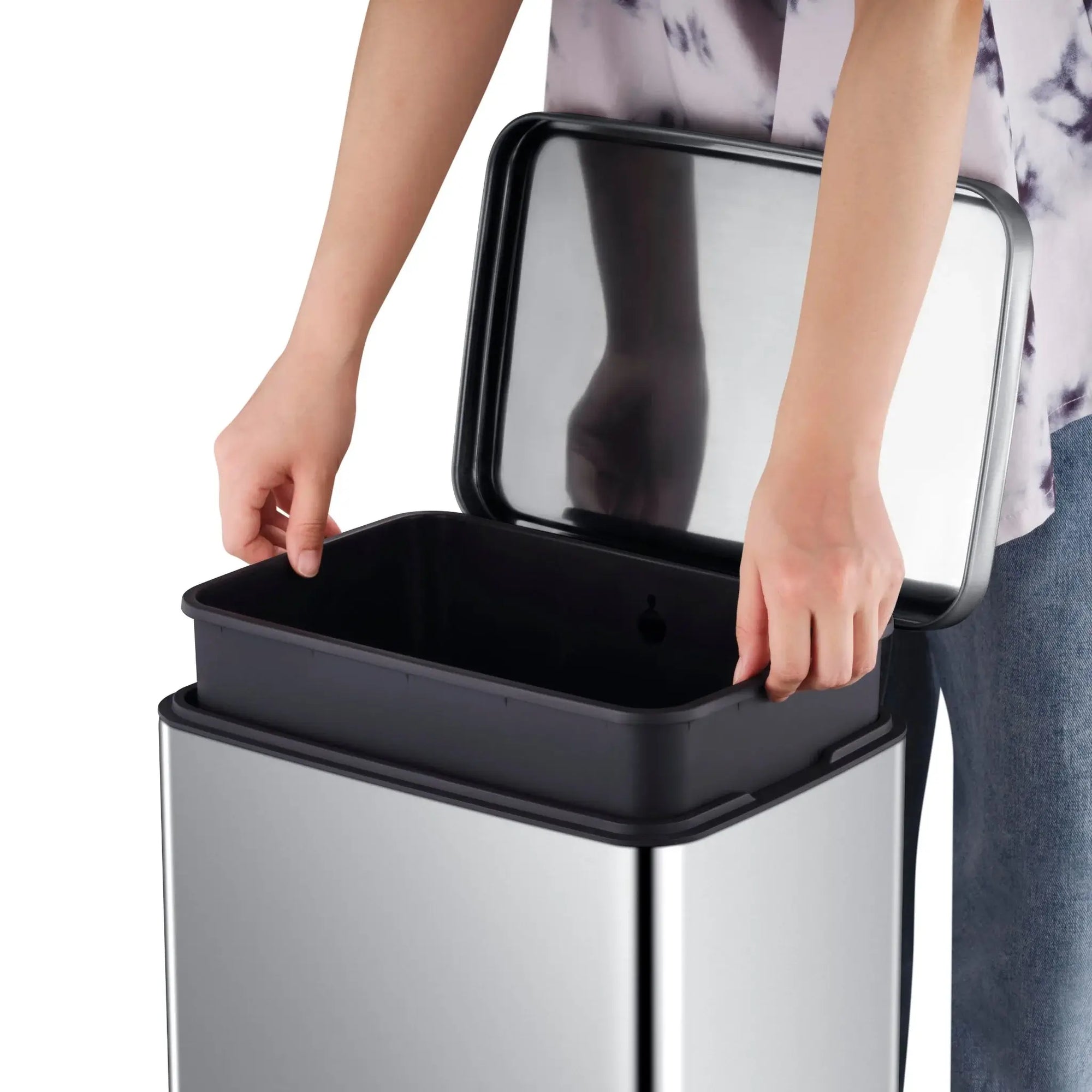 Person opening a stainless steel waste bin