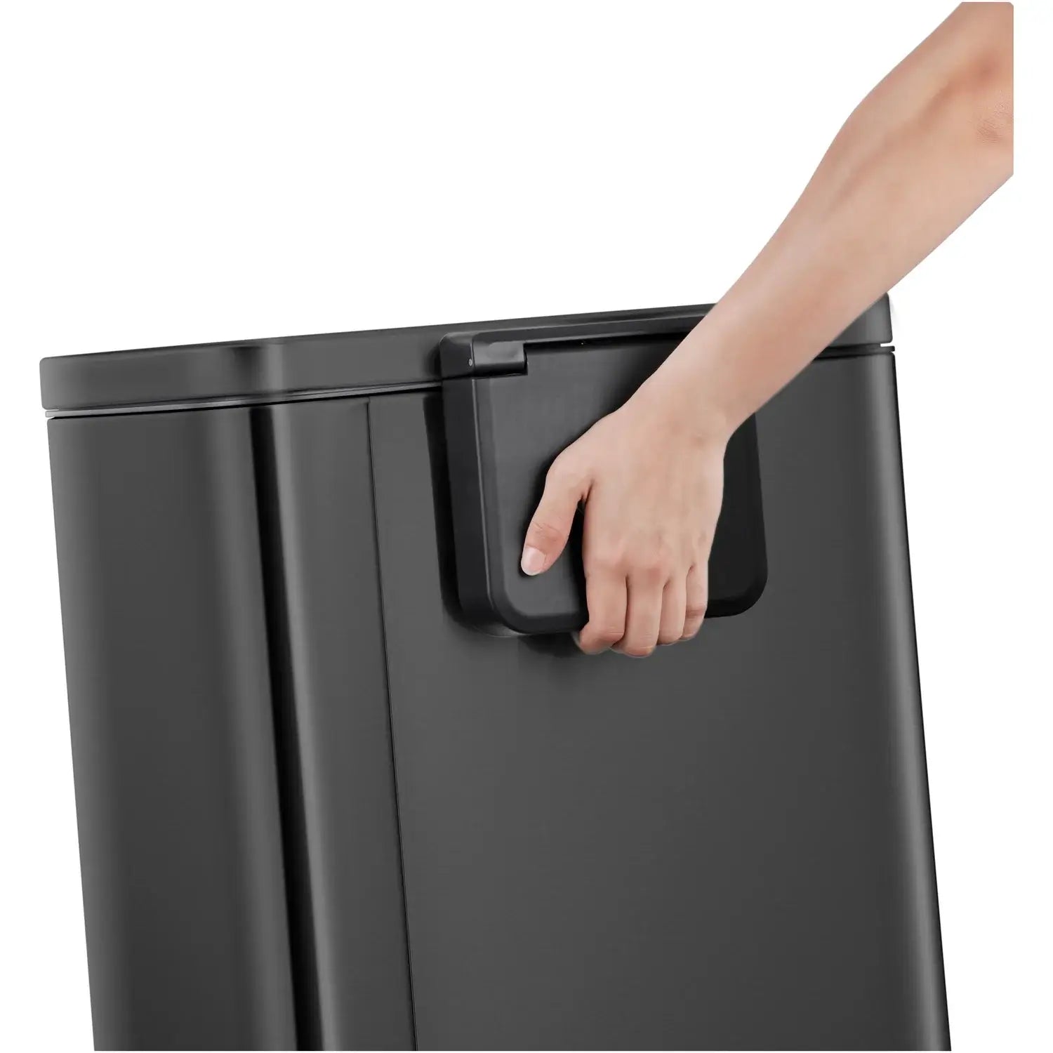 Person using handle on the back of a black waste bin with a white background