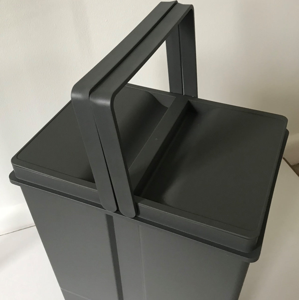The dark grey plastic 58-litre buckets each have handles and individual lids