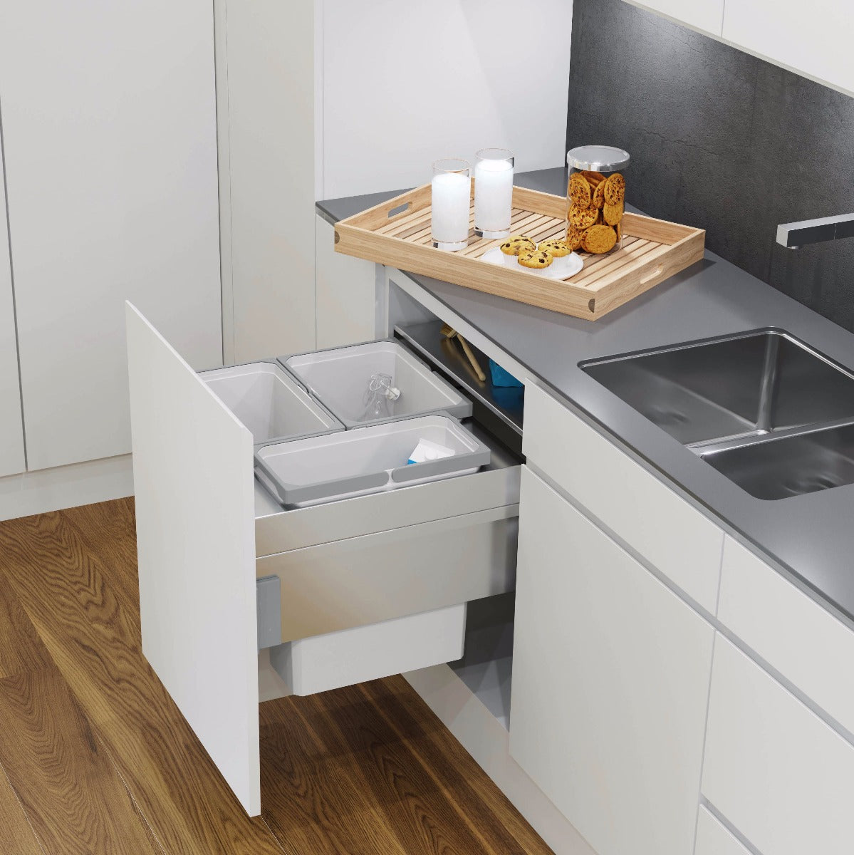 A silver grey Vauth-Sagel integrated kitchen bin with three compartments for separating waste and recycling.