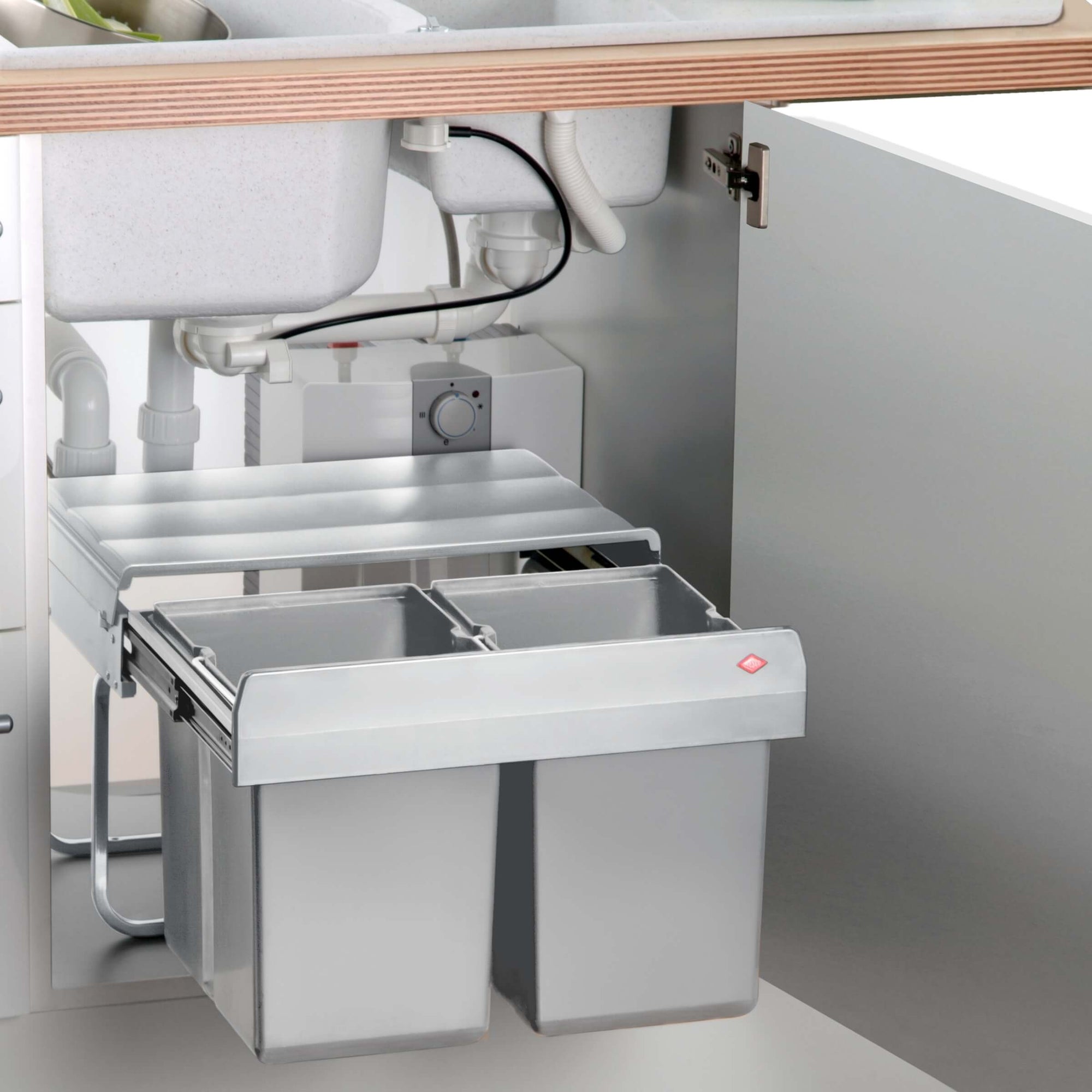 Shorty Manual Pull-out waste bin for hinged doors, paced in an under sink cupboard.