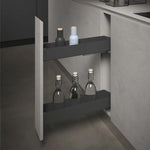 A dark gray pull-out under-cabinet shelf mounted inside a kitchen cabinet, shown with two bottles on the top shelf and three glass bottles on the lower shelf.