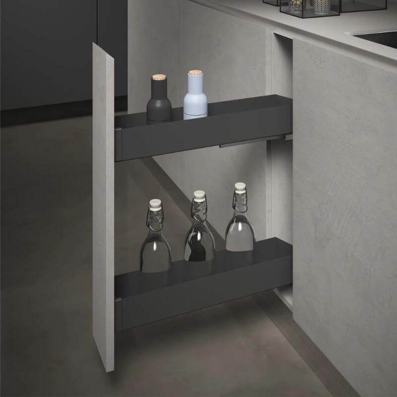 A dark gray pull-out under-cabinet shelf mounted inside a kitchen cabinet, shown with two bottles on the top shelf and three glass bottles on the lower shelf.
