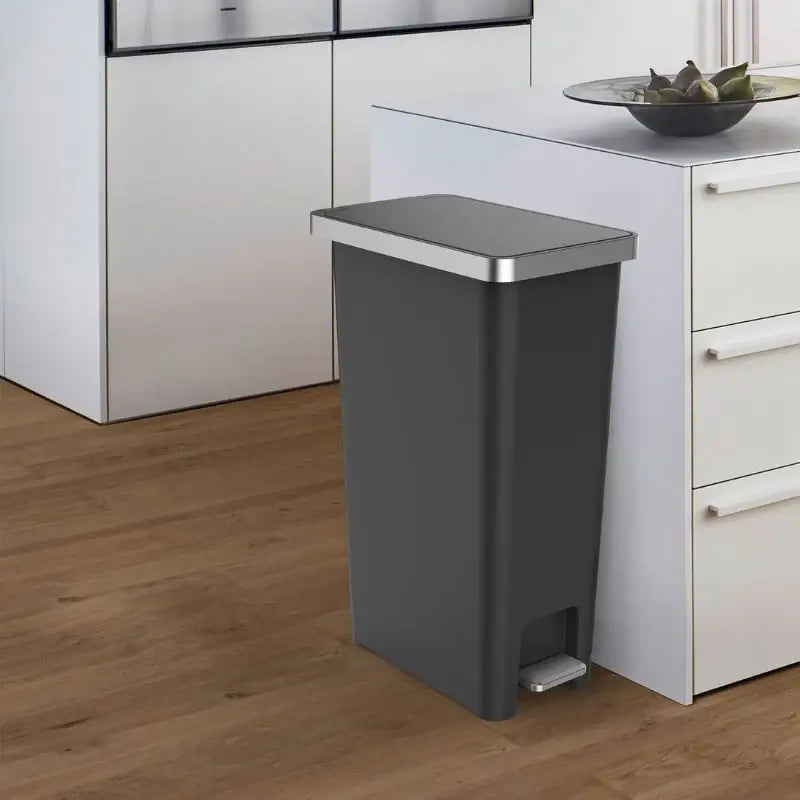 Grey pedal bin in a white contemporary kitchen