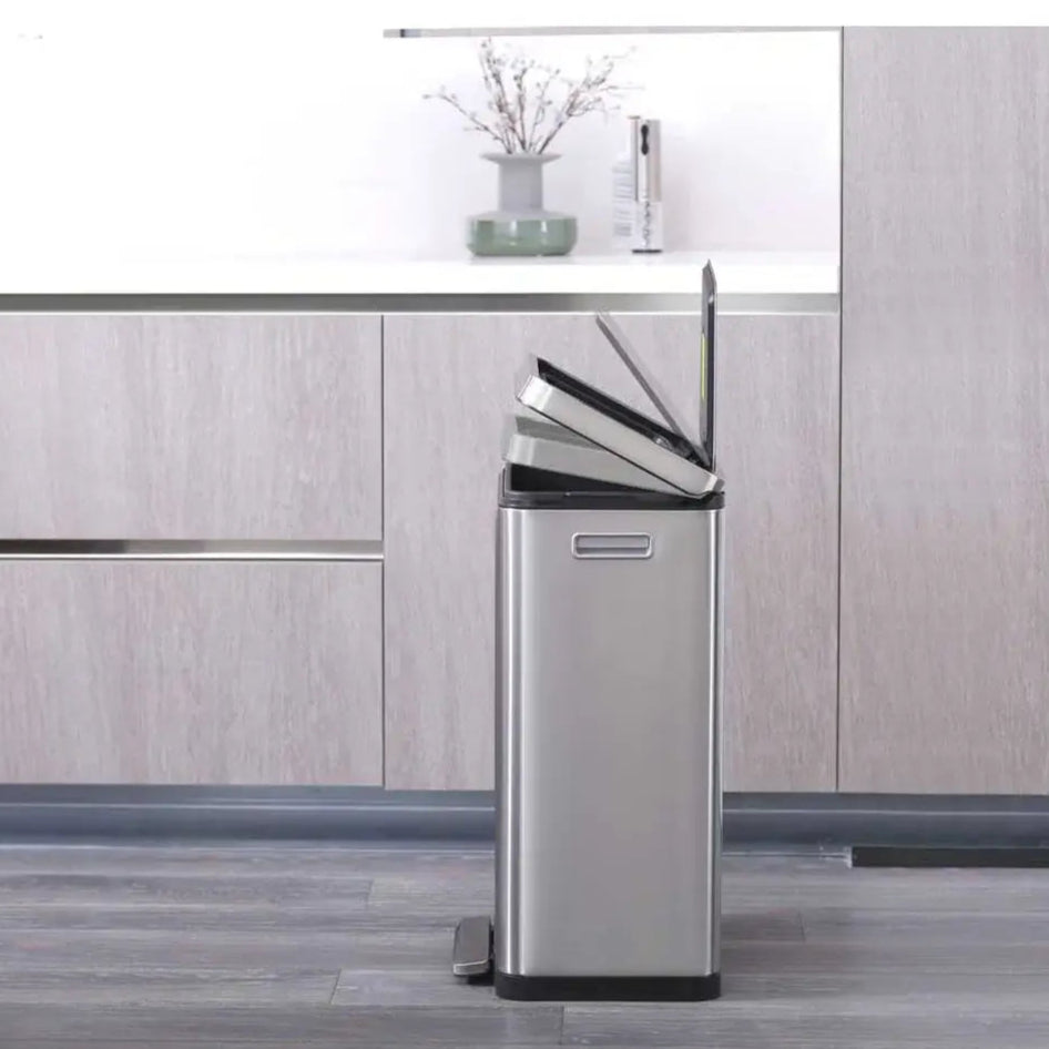 Stainless steel waste bin in a modern kitchen setting