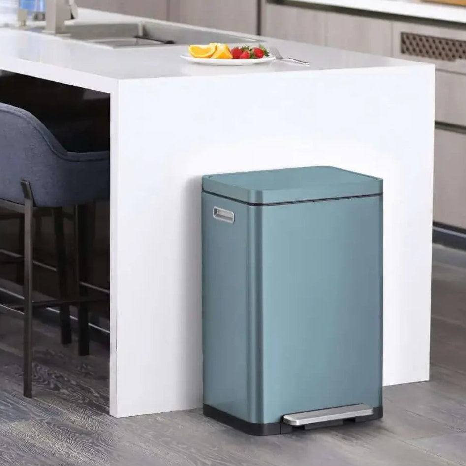 Blue waste bin in a kitchen setting with a counter and stools.